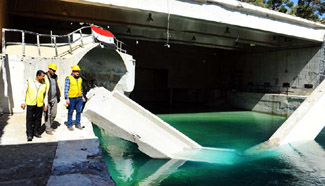 Syrian maintenance workers observe water flow at Ain al-Fijah water spring